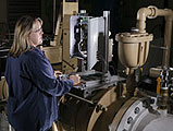 Victoria VanderNoot, an analytical chemist at Sandia, observes operational data displayed by the lab's Unattended Water Sensor