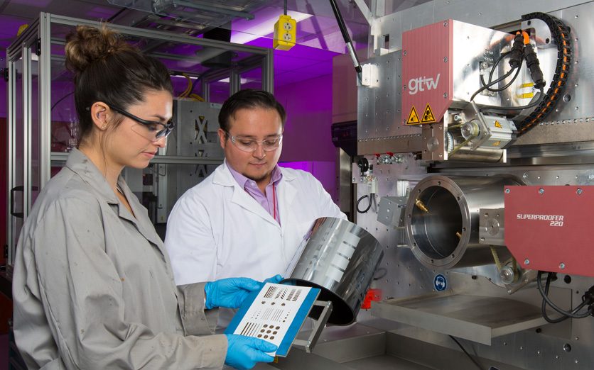 Two Sandia engineers inspecting Superproofer printed item