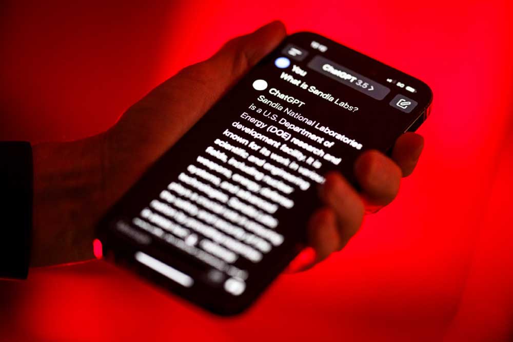 Person holding mobile phone with ChatGPT on screen