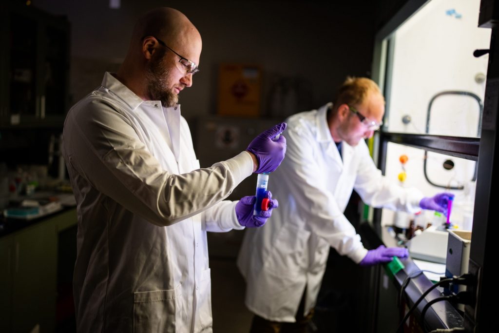 Ryan Davis, left, and former Sandia employee Andrew Knight working on a new material to better absorb PFAS on a large and small scale.