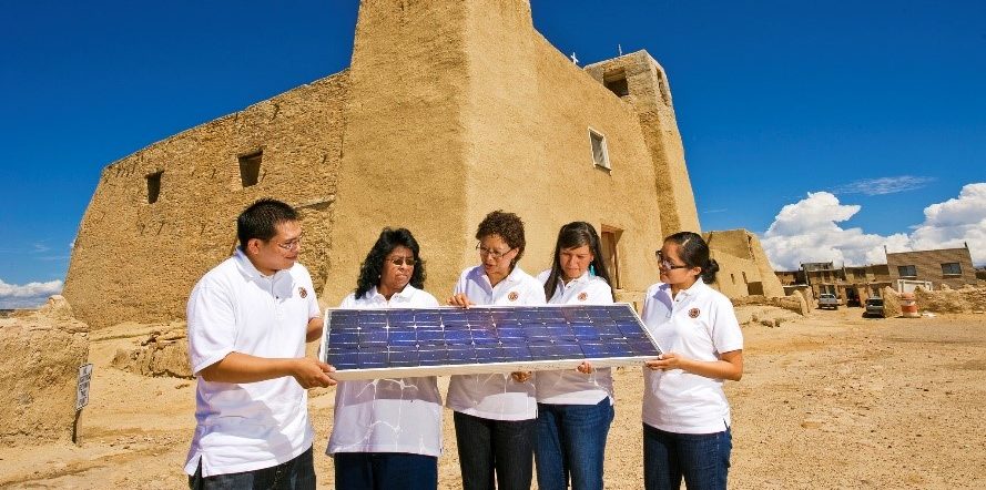 Sandra Begay, center, talks with interns about how a photovoltaic panel works to generate electricity. The DOE has offered the internship program through Sandia since 2002. Picture taken at the Mission San Esteban Rey in the Pueblo of Acoma. Photo credit: Randy Montoya