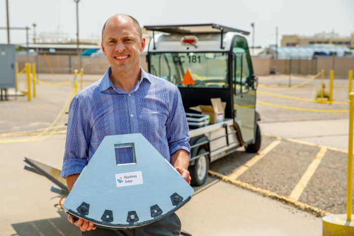 Rocking Solar CEO Darin Palmer holds the rocking mechanism for his patent-pending single-axis tracking design.