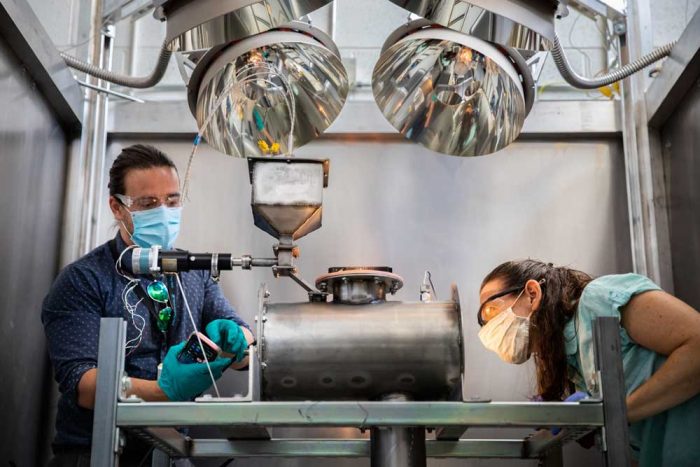 PRODUCTION PROCESS — Evan Bush, left, and Andrea Ambrosini explore using concentrating solar power-generated heat to produce ammonia. (Photo by Craig Fritz)