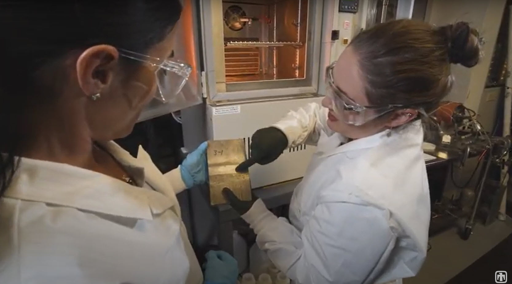 Sandia National Laboratories researchers Rebecca Schaller, left, and Erin Karasz discuss the results of a stainless-steel corrosion test.