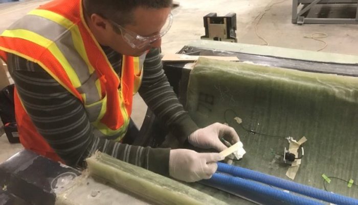 Clean Energy Champion Josh Paquette works on awind turbine in the laboratory.