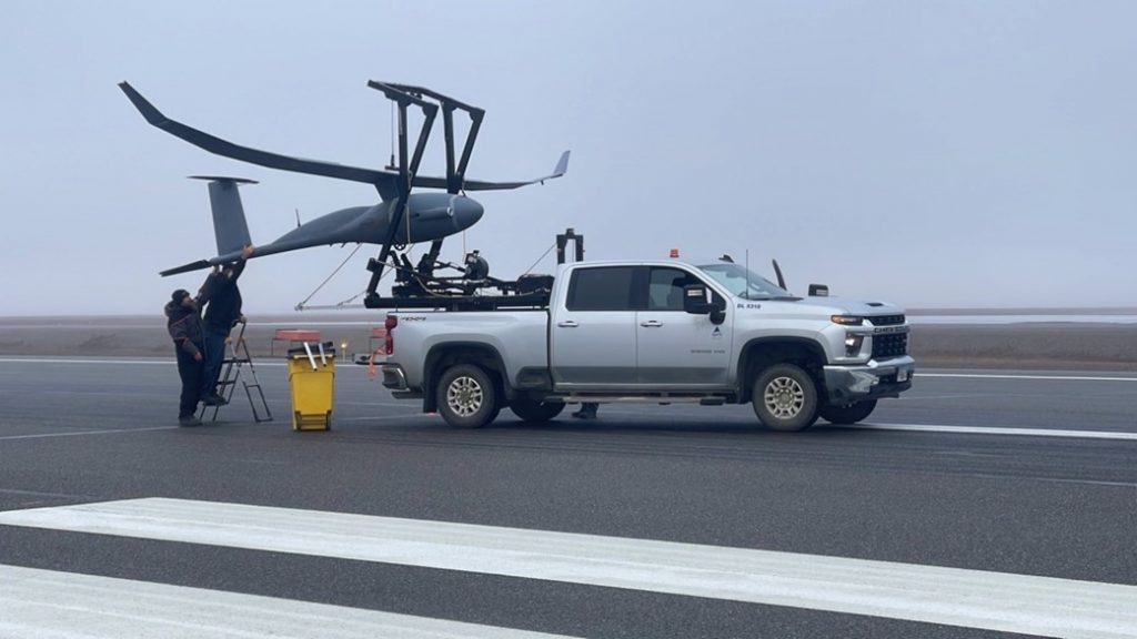 Platform Aerospace ground crews on the runway at Deadhorse, Alaska, loading the 36-foot wingspan Vanilla Unmanned UAS after a successful flight. (Courtesy Platform Aerospace)