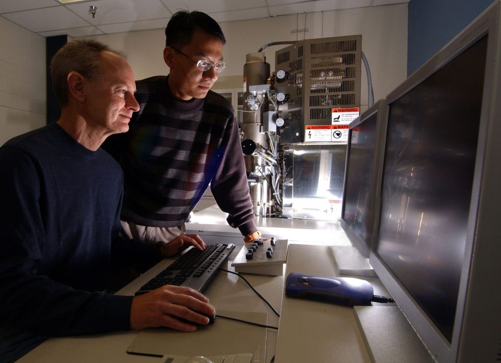 Sandia researcher John Shelnutt and University of New Mexico Ph.D. student Yujiang Song look at platinum at the nanoscale on a new scanning electron microscope at UNM’s Center for Micro Engineered Materials.