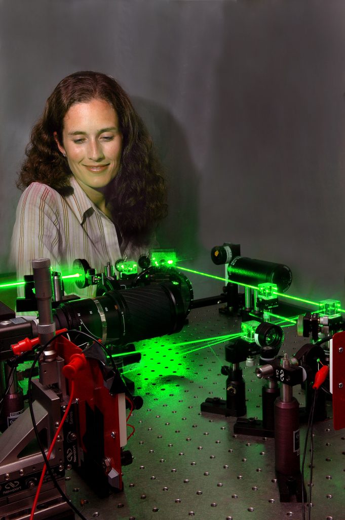 Sandia researcher Bianca Keeler studies very fine motion formerly unobservable by human eye but now revealed by a laser beam interacting with an unusual diffraction grating fabricated at Sandia’s Microelectronic Development Laboratory. The photo was taken using an eye-safe laser and low-light level photographic techniques.