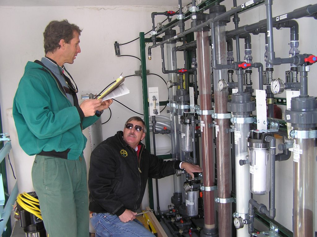 Sandia researchers Brian Dwyer, left, and Randy Everett check out arsenic water testing facilities in Socorro.Download 300dpi JPEG image, ‘water-pic.jpg’, 596K (Media are welcome to download/publish this image with related news stories.)