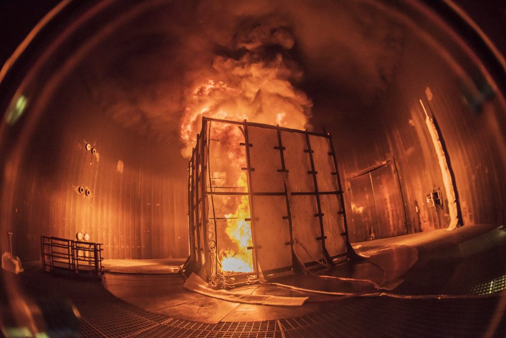 Massive flames billow from a 16-foot-high test enclosure placed within Sandia National Laboratories’ Thermal Test Complex. Researchers collect data from experiments at the complex. (Photo by Randy Montoya) Click on the thumbnail for a high-resolution image.