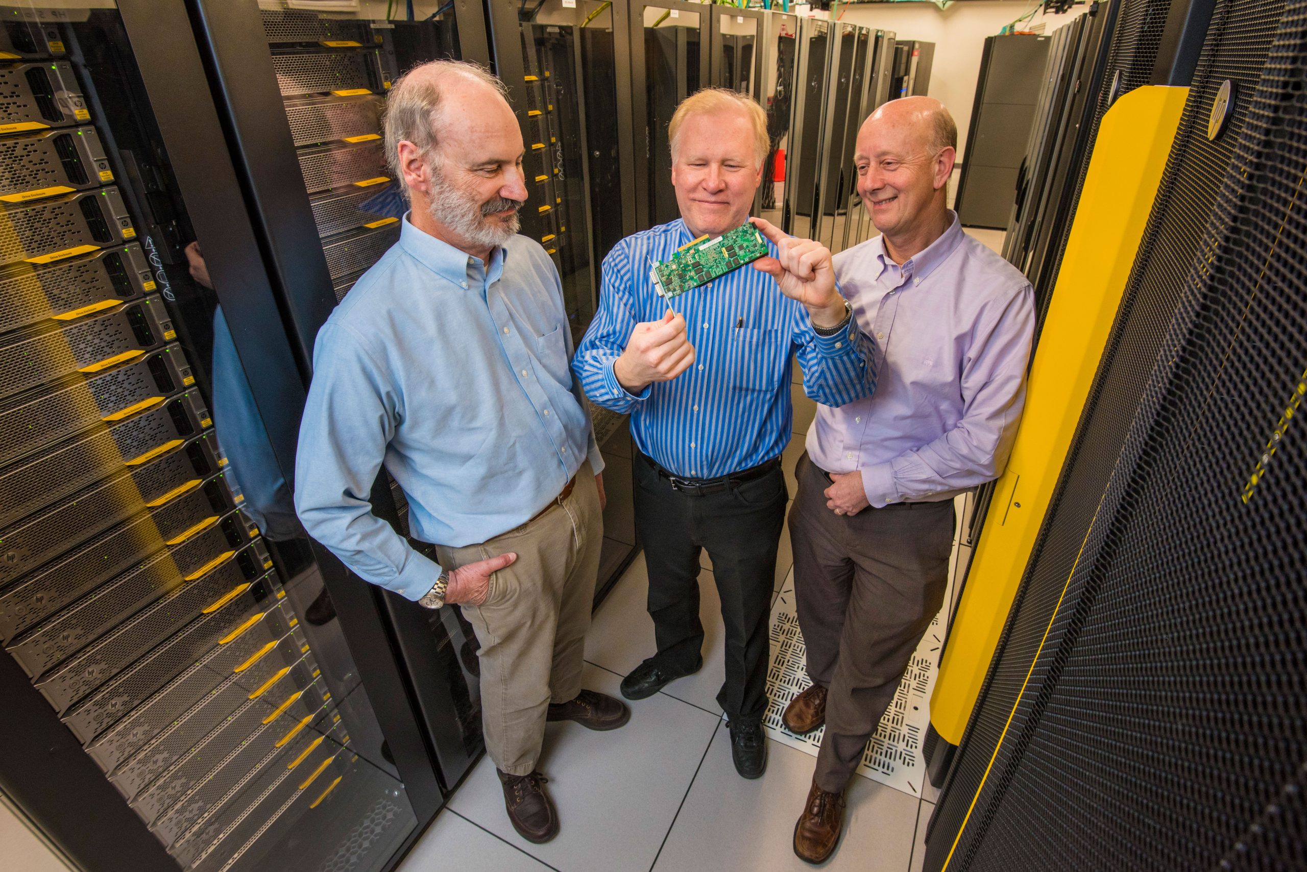 Roger Suppona, John Naegle, and David Follett hold Neuromorphic Cyber Microscope.