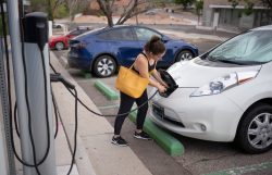 Woman charging an electric car.