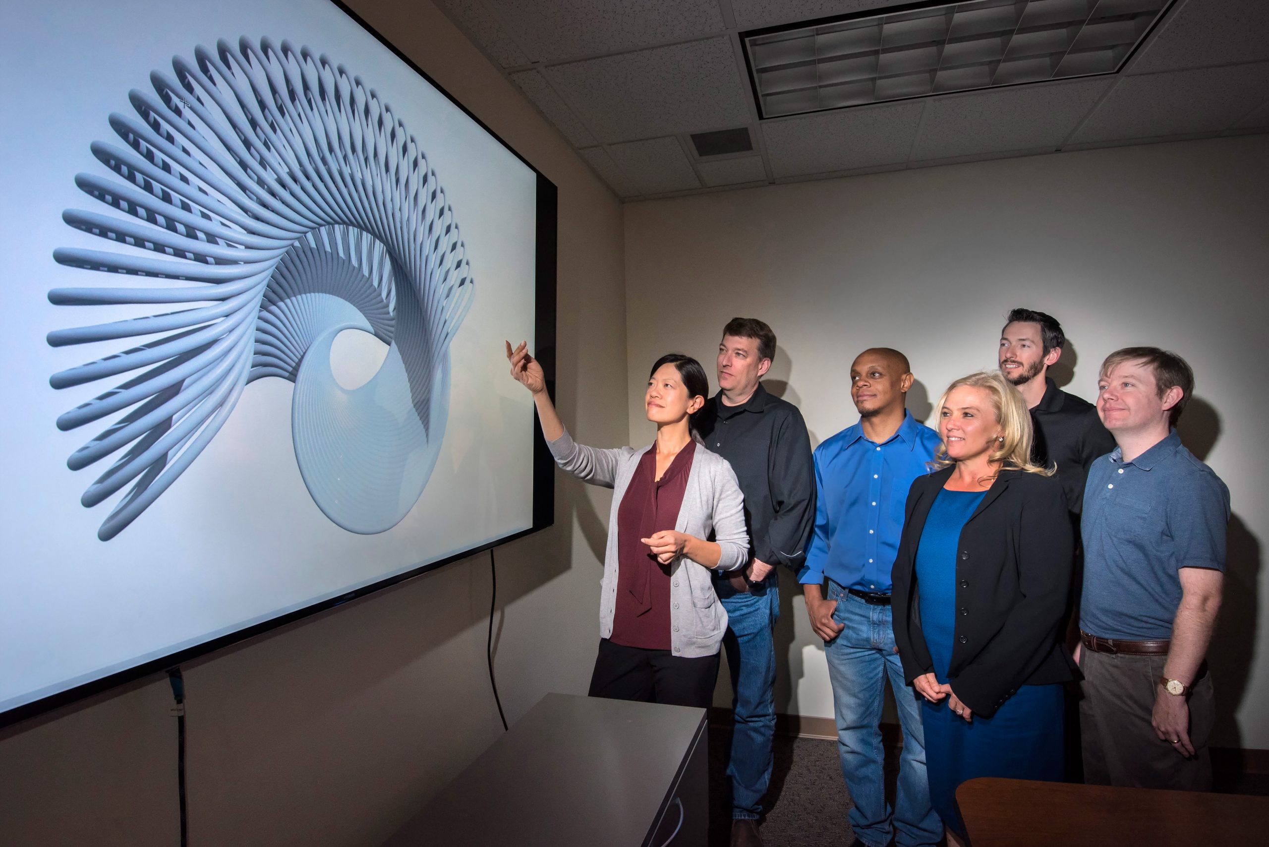 Sandia's MICrONS team examines a sample test object for IARPA's Machine Intelligence from Cortical Networks (MICrONS) project