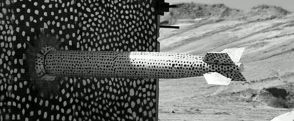 A B61-12 test unit slams into a target at the end of Sandia National Laboratories’ 10,000-foot rocket sled track in a complex forward ballistics test. The test, which mimicked a high-speed accident, allowed engineers to examine safety features inside the weapon.