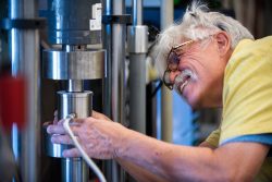 Man fastening something on a metal cylinder