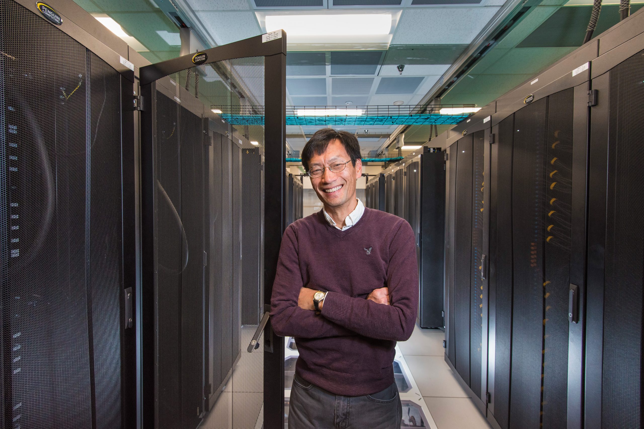 Vitus Leung between two stacks of supercomputers.