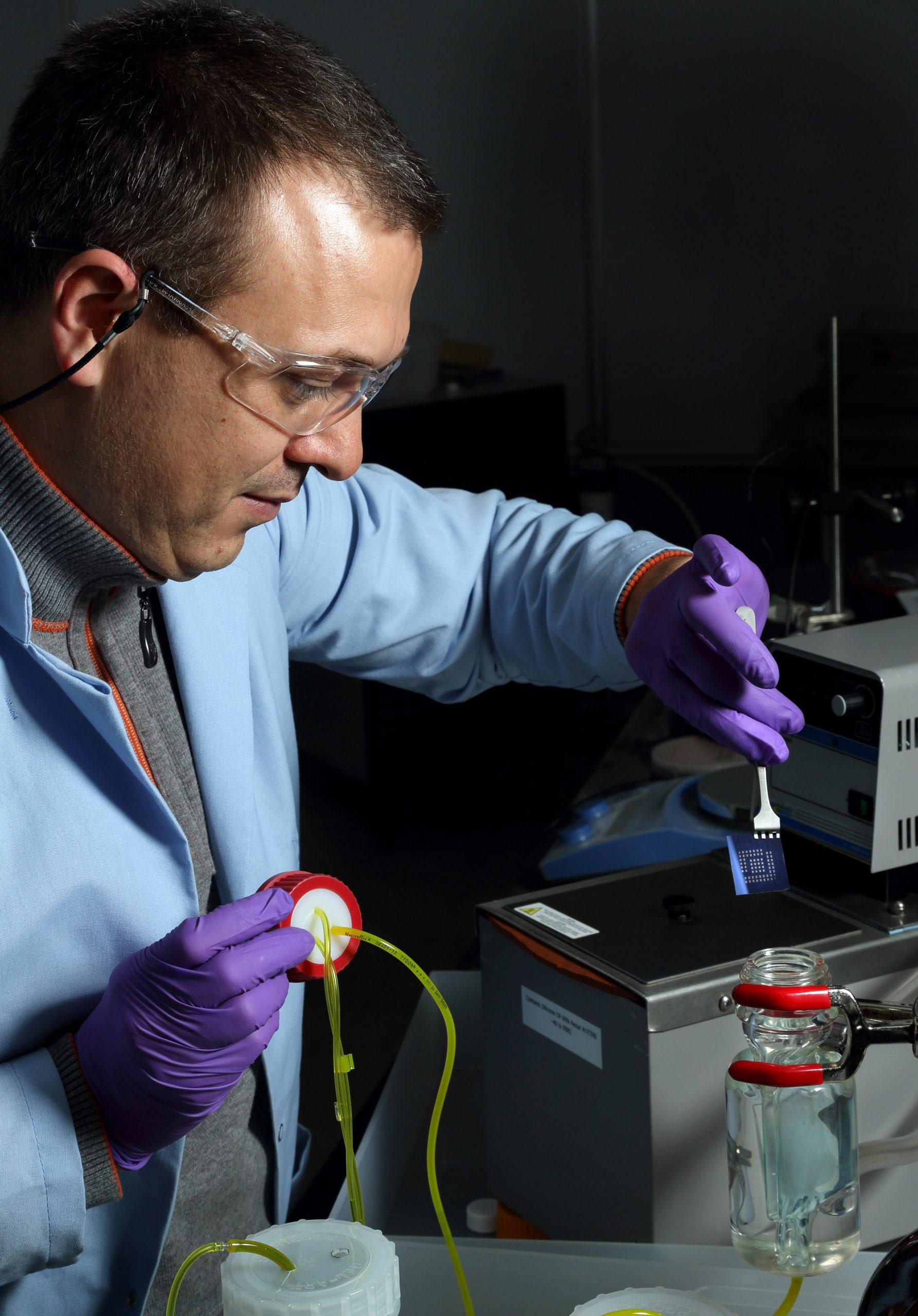 Sandia National Laboratories researcher Vitalie Stavila inserts a substrate patterned with electrodes into a temperature-controlled liquid-phase reactor for depositing MOF thin films. Sandia's research team plans to combine MOFs with dye-sensitized solar cells, a technique it believes will lead to advancements in photovoltaic technology. (Photo by Dino Vournas)