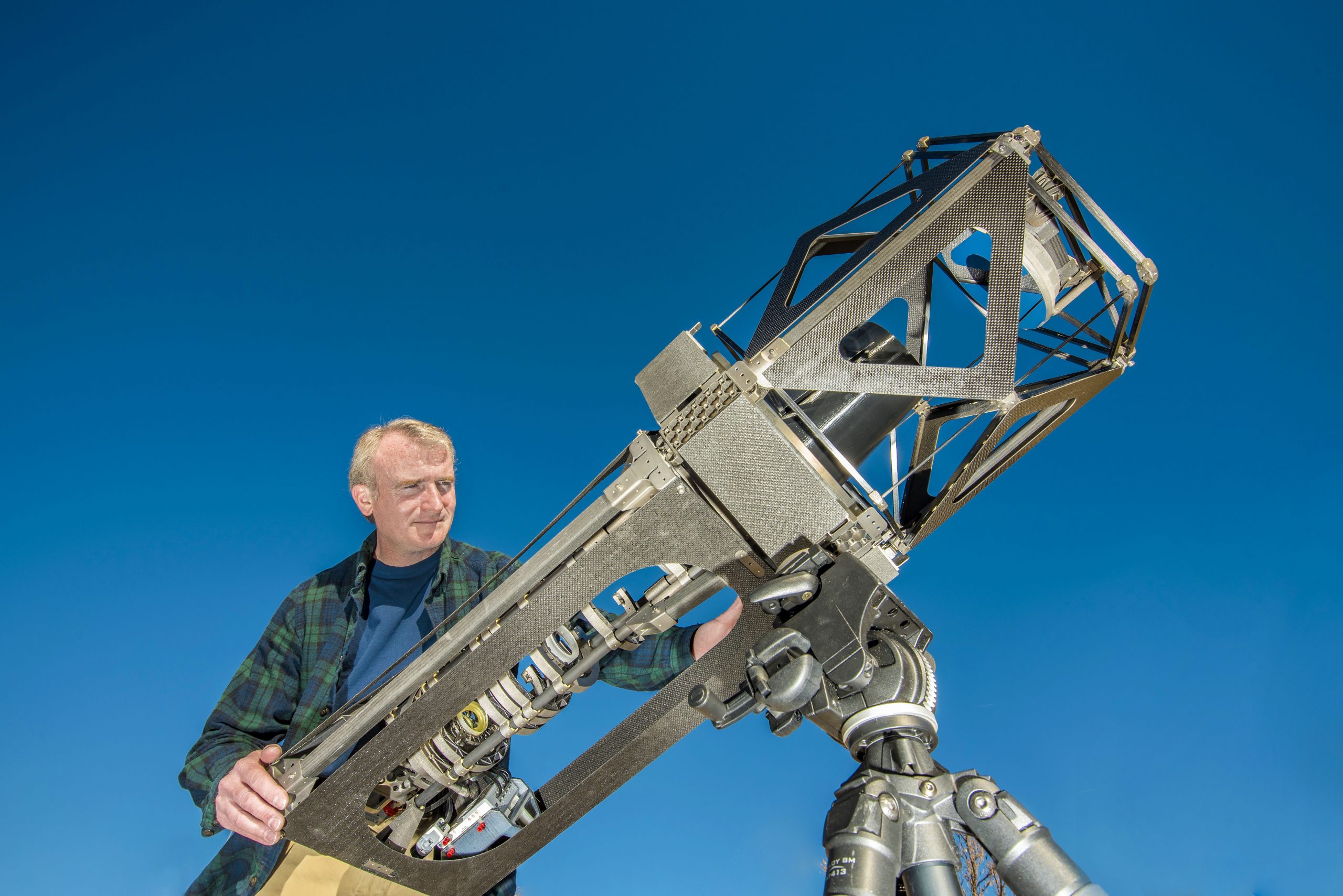 Sandia National Laboratories project lead Ted Winrow with the telescope he and his team built using advanced manufacturing techniques.