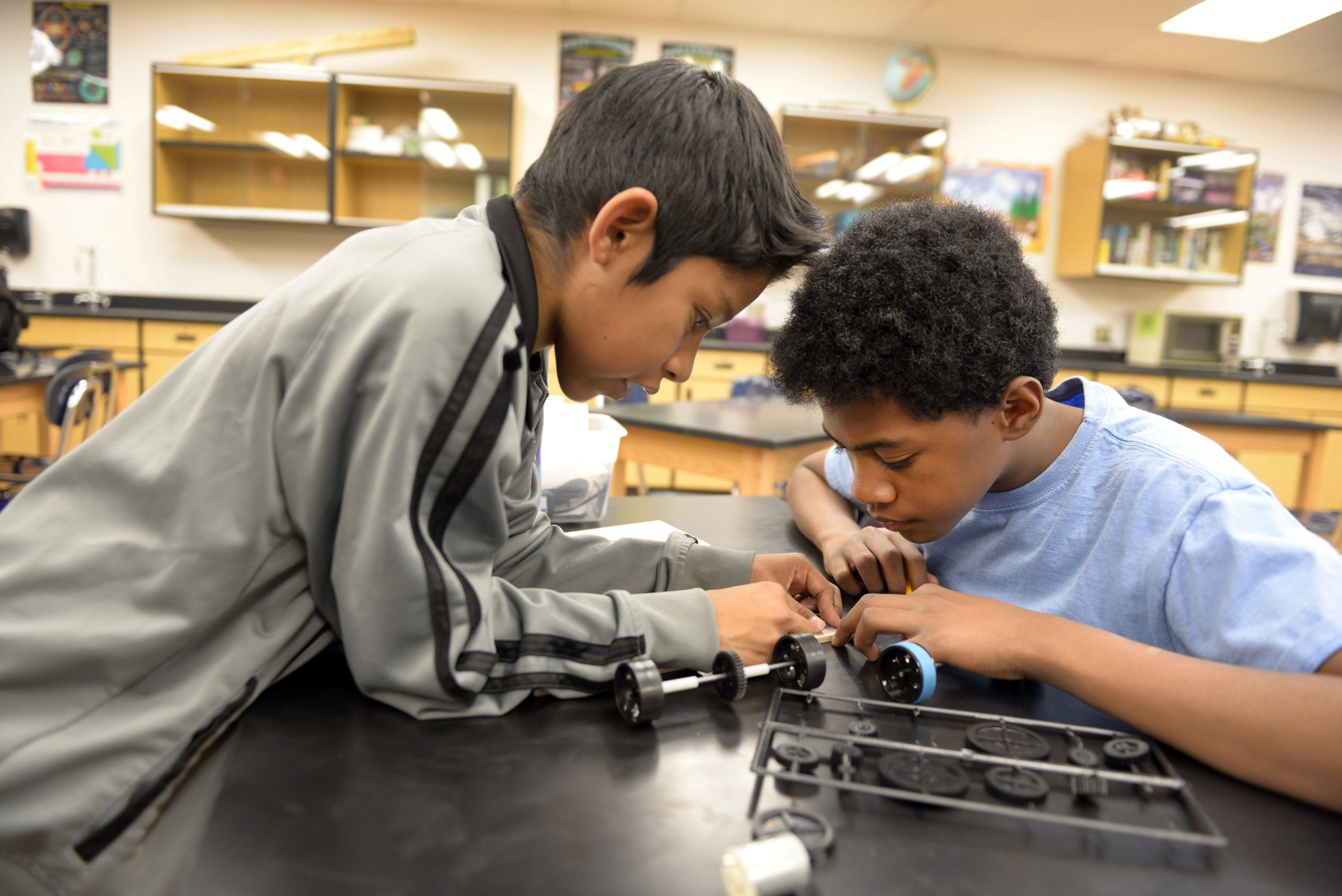 Two boys design their electric car.