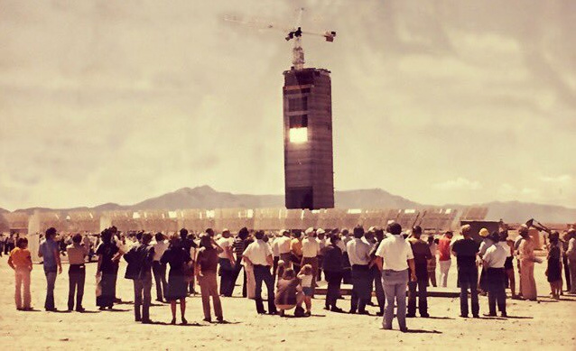 Historical sepia toned photo of a crowd looking at the Solar Tower.