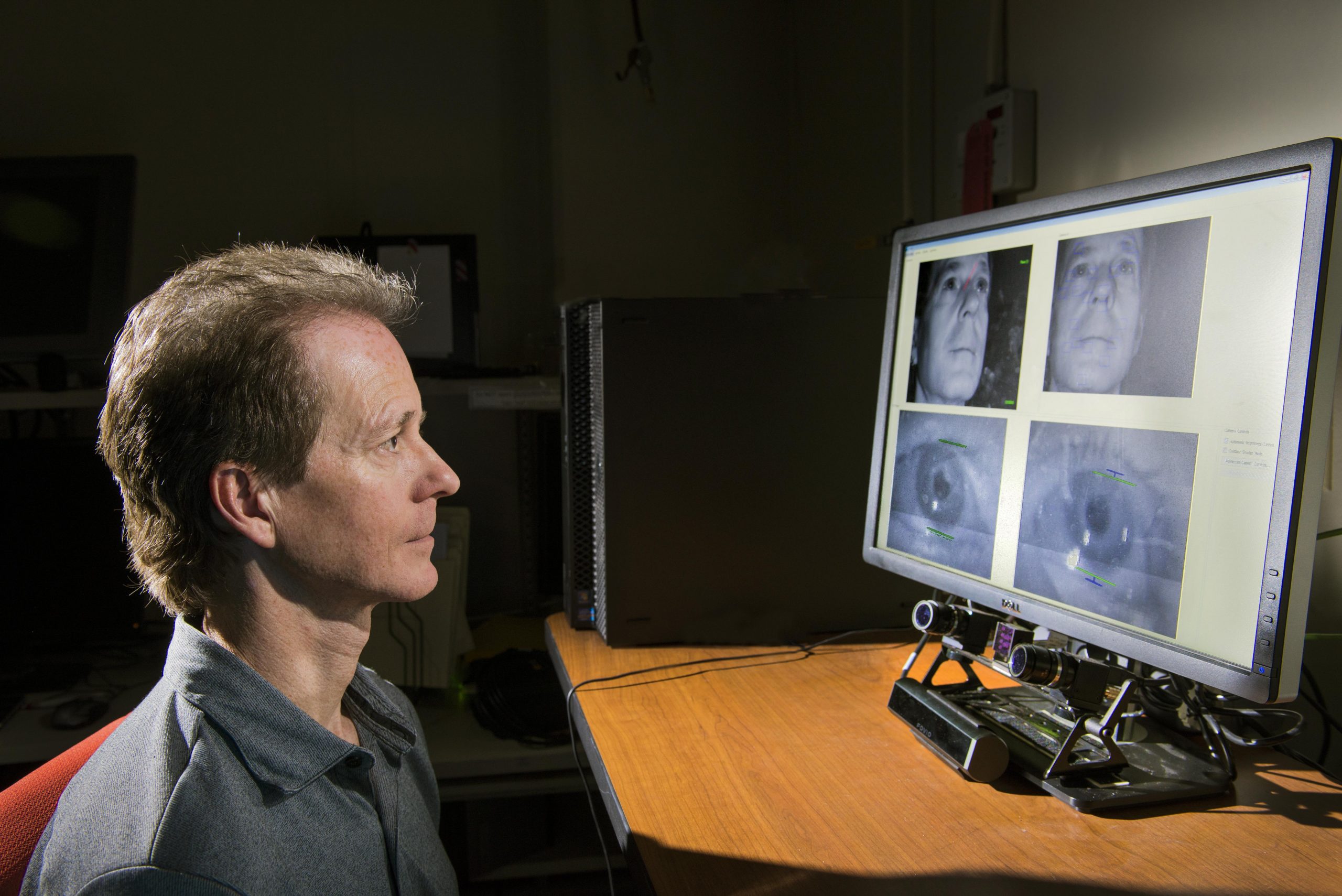 Sandia National Laboratories researcher Mike Haass demonstrates how an eye tracker under a computer monitor is calibrated to capture his eye movements on the screen. Haass and others are working with EyeTracking Inc. to figure out how to capture within tens of milliseconds the content beneath the point on the screen where the viewer is looking. (Photo by Randy Montoya) Click on the thumbnail for a high-resolution image