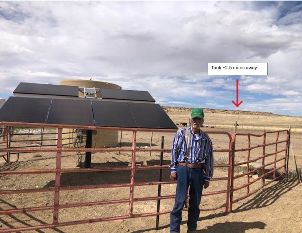 Johny Francis sees the success of the new watering system on his ranch before his passing earlier this year. The arrow indicates the location of the tank that gravity feeds drinkers around the ranch. (Photo courtesy of Mike Lisk) Click on the thumbnail for a high-resolution image.