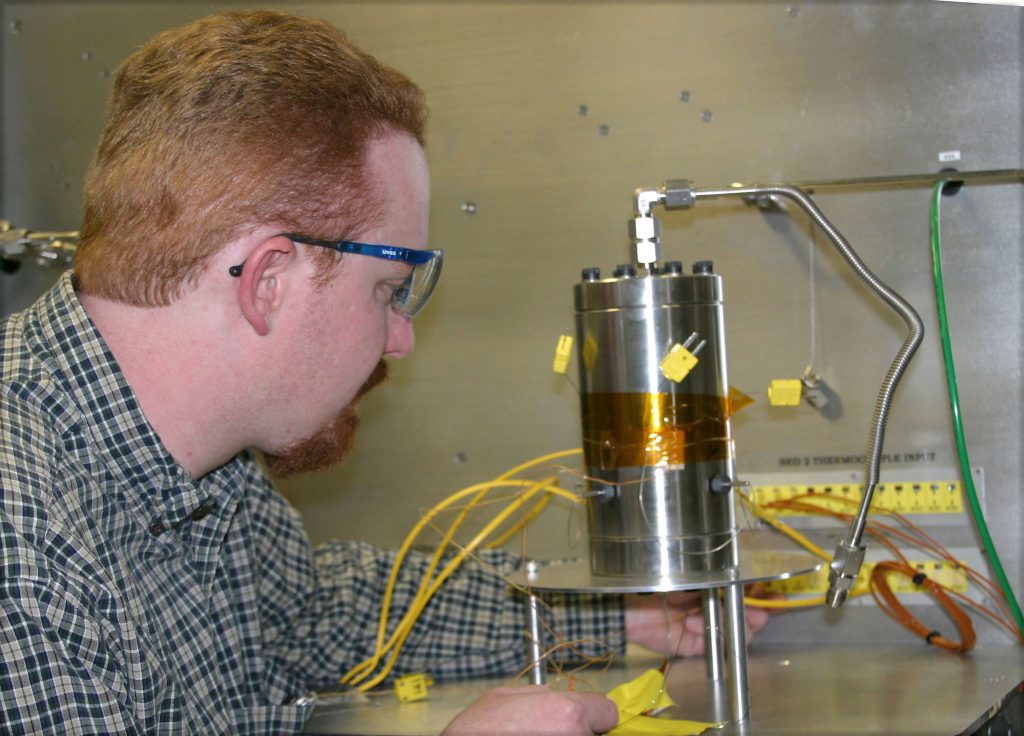 A critical aspect of hydride storage tank development is the act of recharging and discharging hydrogen. Here, Sandia National Laboratories engineer Mark Zimmerman integrates a hydride bed with temperature monitoring sensors.