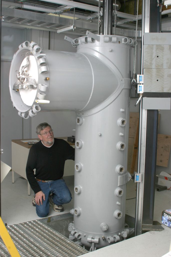 GASIFICATION REACTOR — Technical Staff Member Al Salmi examines a gasification reactor at the Combustion Research Facility being developed to help study the behavior of coal gases under pressure.