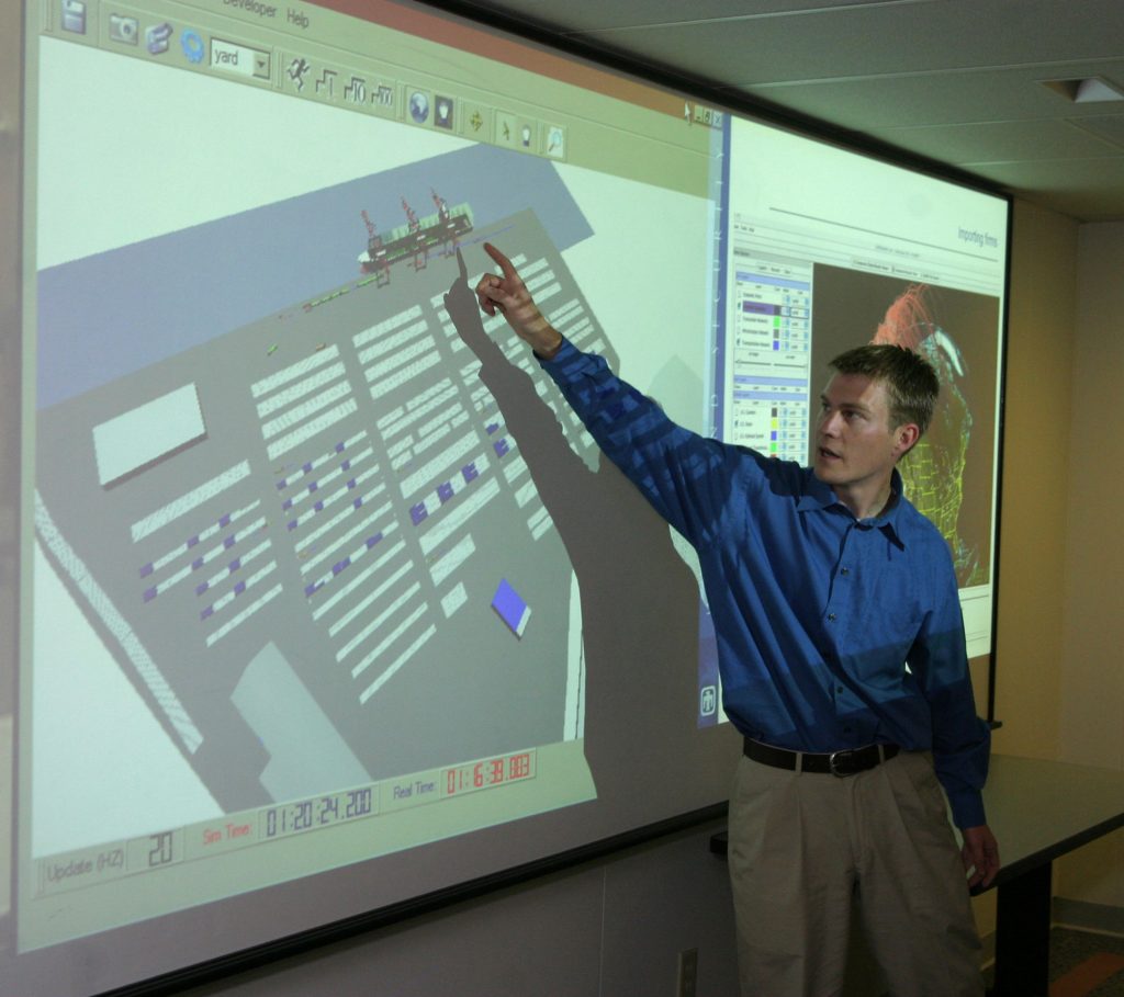 Sandia researcher Andy Vaughn shows an example of how simulations developed at Sandia can help evaluate new sensor technologies and suggest ways to minimize impacts by determining the most optimum technologies and configurations. In this case, cargo inspection equipment at a seaport increases the probability of detecting illicit materials but also disrupts operations and causes large delays when used in certain configurations.