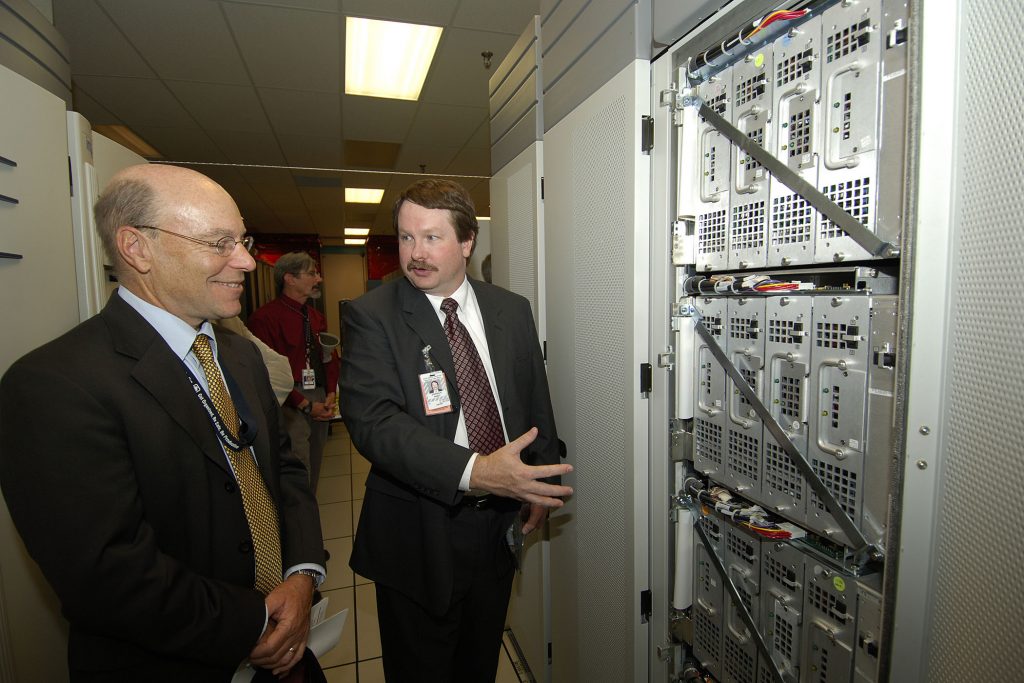 VP RICK STULEN and Intel designer Stephen Wheat look at the innards of an ASCI Red rack. The machine’s easy accessibility made it possible to upgrade the processors, assuring it would remain one of the world’s fastest computers for nearly a decade.