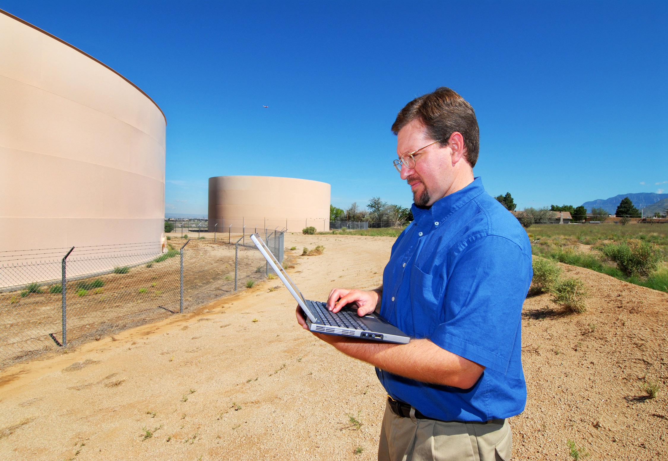 JUST CHECKING — Bill Hart, project lead for the Sandia team that developed water system software, does some field checking in the Albuquerque foothills.