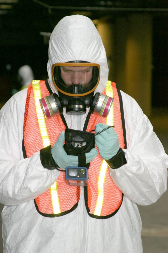 BROOM research has included demonstrations and exercises with San Francisco International Airport and other model facilities. Here, a technician outfitted in HazMat gear enters sample information into the BROOM PDA device.