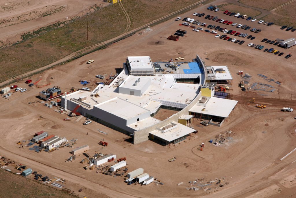 CINT Rising — The hub facility of Sandia/Los Alamos joint Center for Integrated Nanotechnologies rises north of Kirtland Air Force Base. The building's three wings house a characterization lab containing the most vibration sensitive instruments, a synthesis lab that includes chemical and biological labs, and an integration facility which includes a Class 1000 clean room and mobile clean rooms with higher ratings.