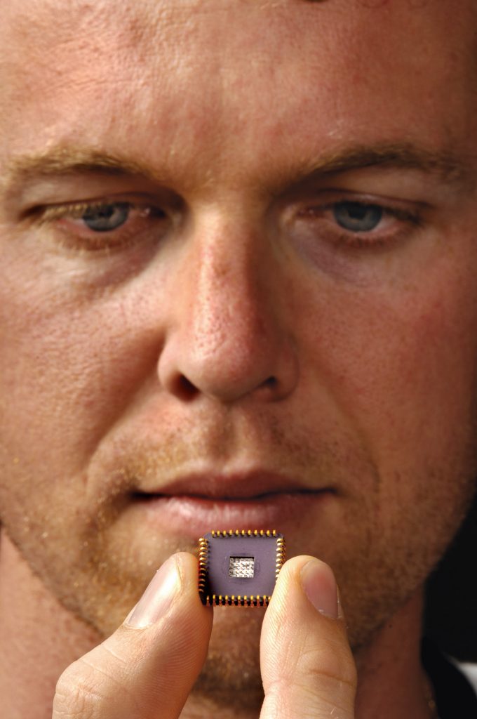 JEB FLEMMING, project lead for the ElectroNeedle platform, holds a test version of the device. The prickly parts are in the center of the package. A production version could be even smaller and simpler.