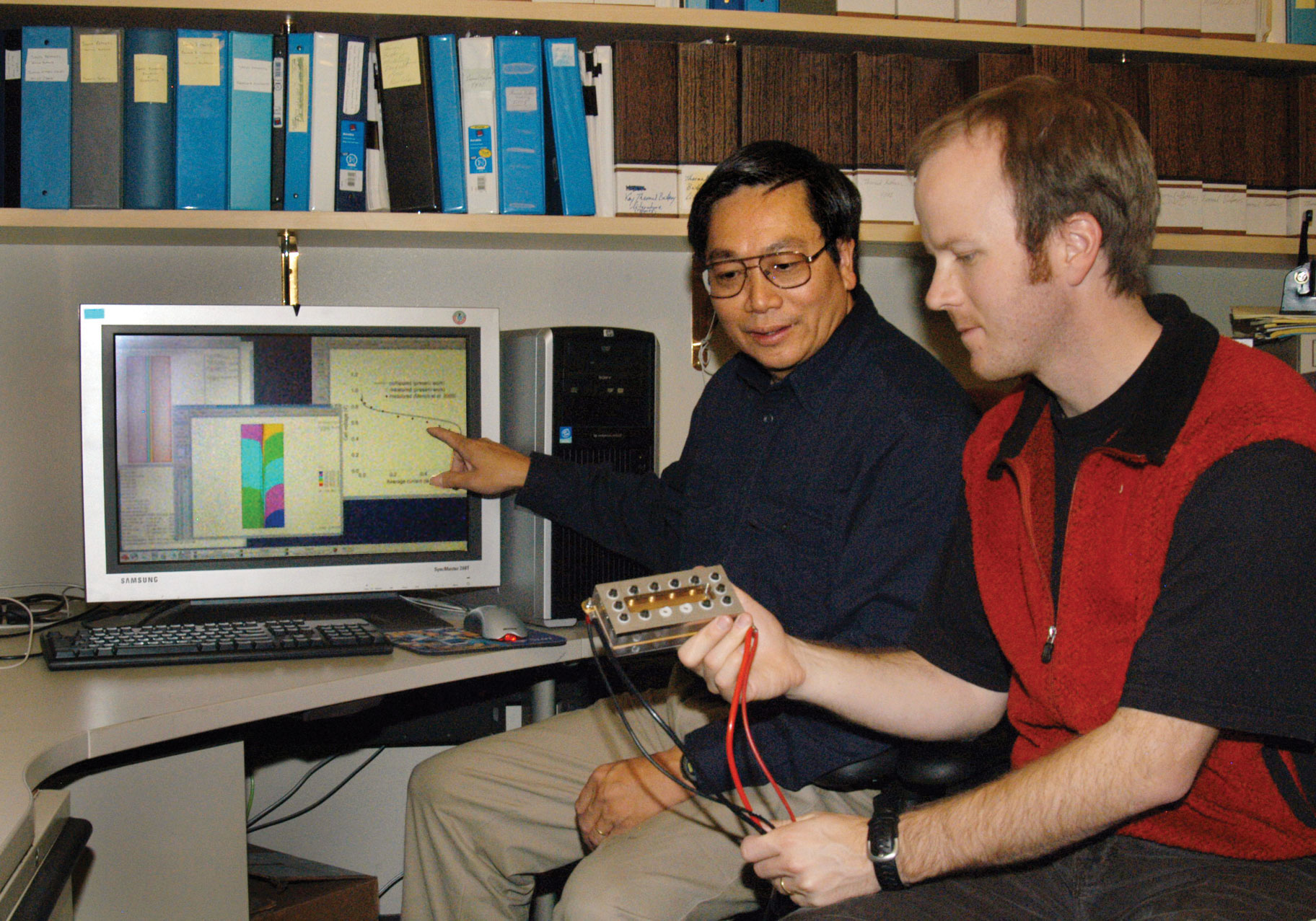 COLLABORATION — Sandia researchers Ken S. Chen, left, and Mike Hickner are collaborating on their research to study PEM fuel cells. Ken is developing computational models to describe the phenomena while Mike is performing physical experimentation.