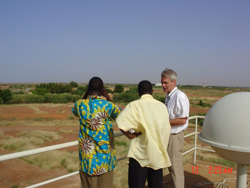 Mark Ivey, right, and colleagues from Niger discuss the deployment of ARM’s Mobile Facility near Niger's capital city, Niamey.