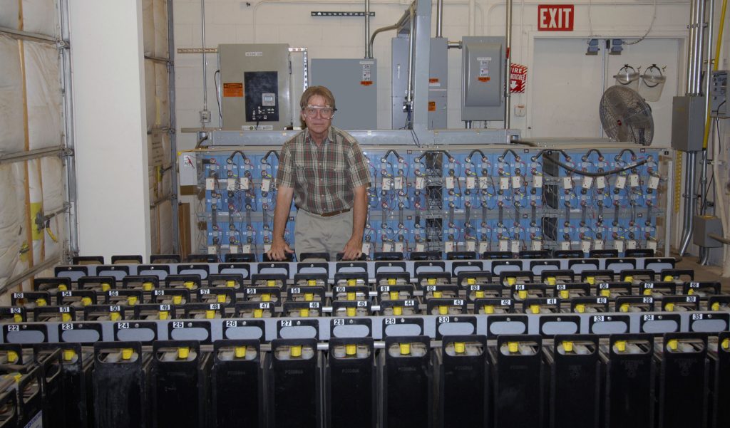 JERRY GINN displays some of Sandia’s battery storage capability. Energy storage is an integral part of the Energy Surety Microgrid.