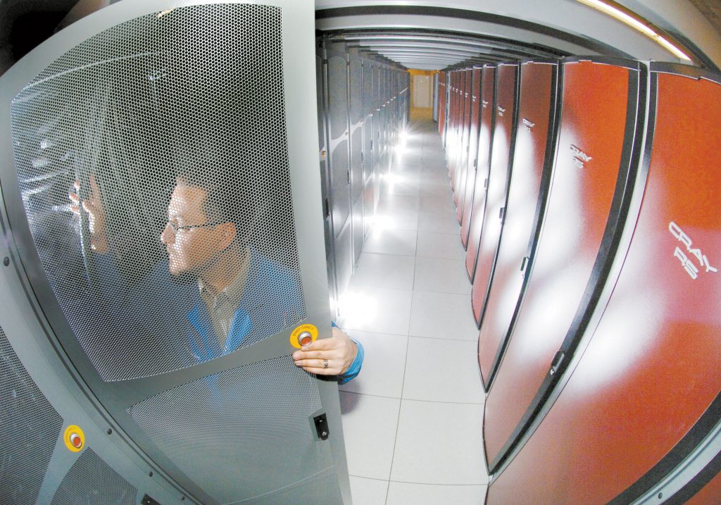 RED STORM — Cray contractor Jason Repik checks out a Red Storm panel. Red Storm has been judged to be the world’s most efficient supercomputer in two of six categories.