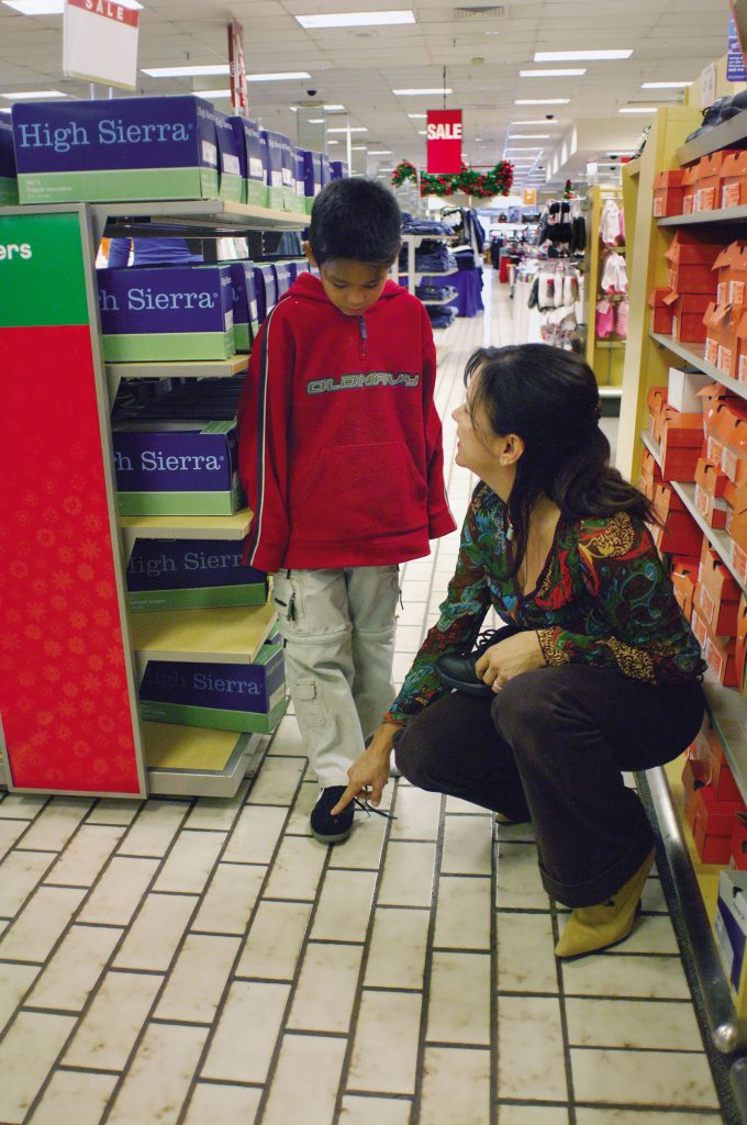 An APS student, his own sneakers two sizes too big, found a pair of shoes that were just his size. He selected shoes that “look good on me.”