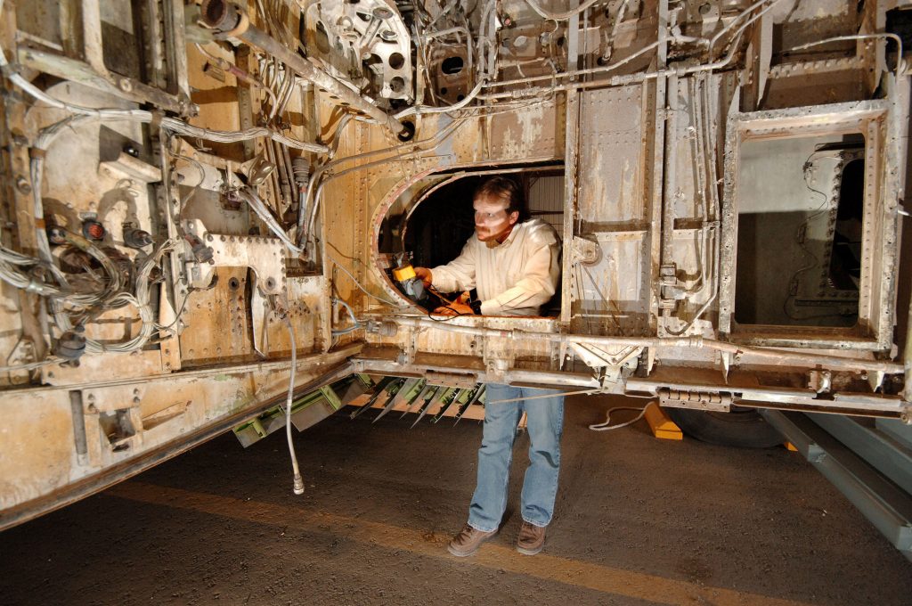 Kevin Howard prepares to acquire PASD data on electrical wiring in the wheel well of a retired Boeing 727.