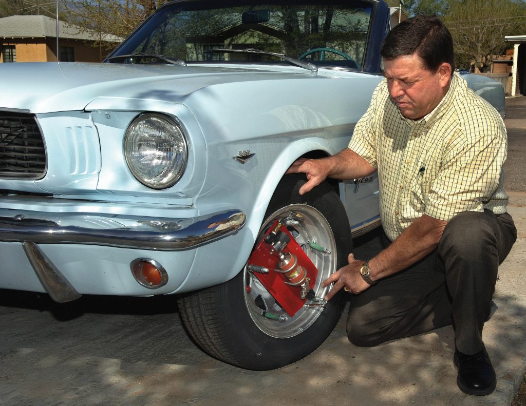 Dale Petty demonstrates the automatic tire pressure maintenance system using wheel-mounted high-pressure nitrogen bottles.