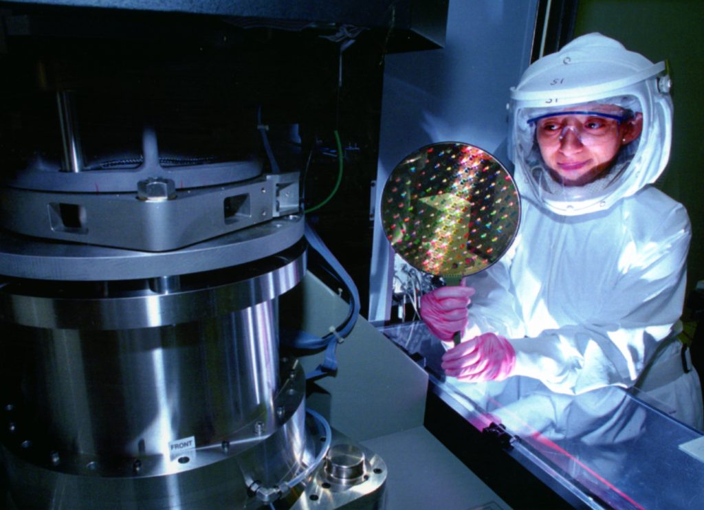 Technician Denise Carrillo inspects a newly metallized wafer in the Microelectronics Development Laboratory at Sandia National Laboratories. (Photo by Randy Montoya)Download 150dpi JPEG image, 'Carrillo.jpg', 752K