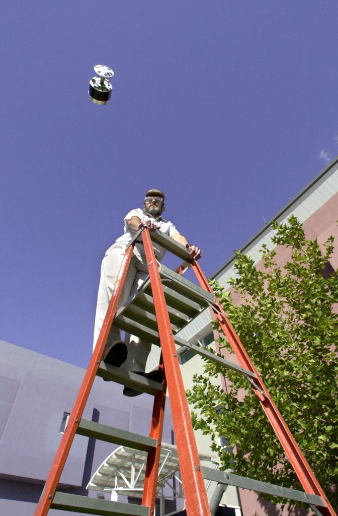 ONE GIANT LEAP — Barry Spletzer of Sandia National Laboratories’ Intelligent Systems and Robotics Center shows how high the new hopping robots can go. This one leaps 10-20 feet high on each jump. The Sandia researchers have achieved hops as high as 30 feet with their unique combustion approach.