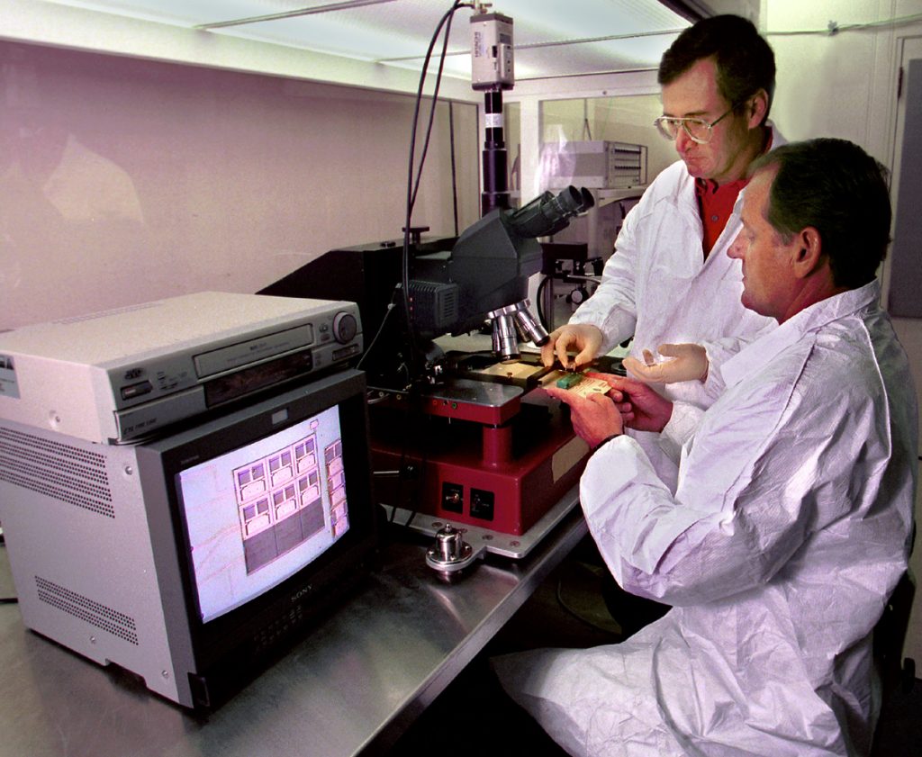 POSSIBLE SPACE EXPLORATION -- Sandia researchers Ernie Garcia (standing) and Ed Vernon examine a micromirror that may one day be part of the Next Generation Space Telescope.