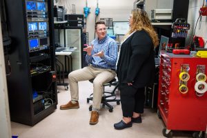 Sandia National Laboratories scientists Alex Bates and Loraine Torres-Castro talk about positioning a battery that's undergoing testing at the Battery Abuse Testing Lab. Their research on electric vehicle batteries aims to detect battery failures more quickly. (Photo by Craig Fritz) Click on the thumbnail for a high-resolution image.