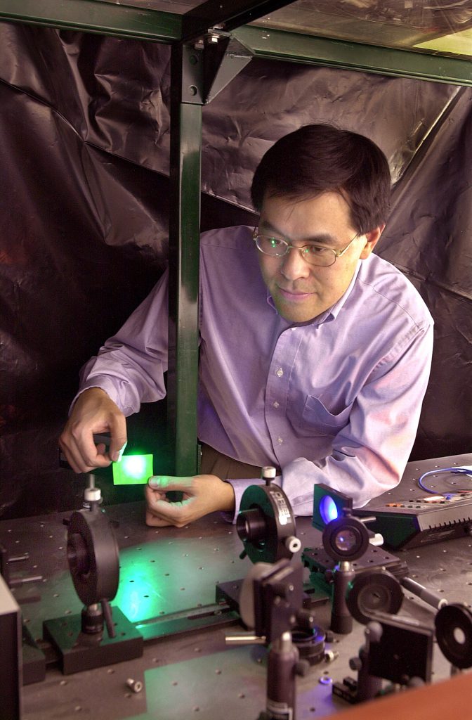 Sandia scientist Jung Han adjusts laser pumping on a prototype ultraviolet VCSEL surface.