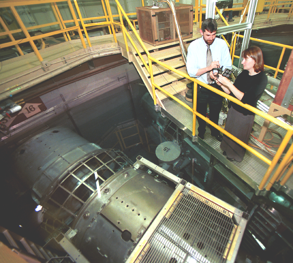 ENERGETIC EXPERIMENT -- Sandia National Laboratories researchers Chris Deeney, left, and Christine Coverdale inspect material samples used to test radiation effects produced by Sandia's Z machine, the world's most powerful X-ray source.