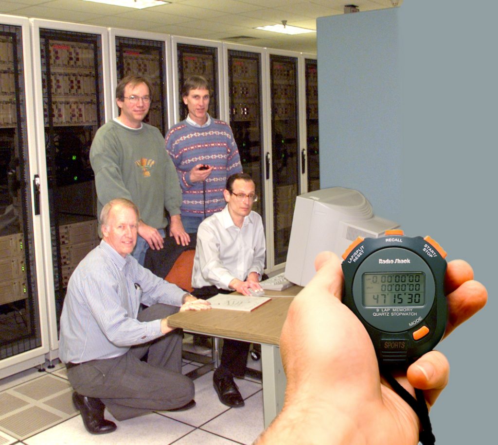 New computational sorting record: (from left) Milt Clauser and Carl Diegert of Sandia, with Chris Nyberg (president, Ordinal Technology Corporation), and David Cossock (Compaq Computers) attend the world-record data speed-sort achieved by Sandia's Kudzu computer. Nyberg's company was the former world record holder.Download 150dpi JPEG image, 'kudzu.jpg', 1MB