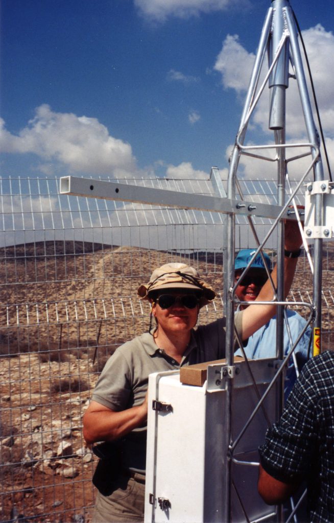 SANDIA'S MIDEAST PROJECT Leader David Betsill installs monitoring equipment with Israeli counterpart at the Lehavim, Israel ecological research station.