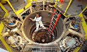 Roberta Hanes, a contractor in the Saturn Operations Dept., removes volt monitors from the center section of the Saturn pulsed power accelerator following a recent shot. In recent months, the Labs' pulsed power team has conducted about two shots a day inside Saturn, one of four major accelerators currently operated by Sandia. To receive a copy of this photo for publication, contact Julie Clausen.